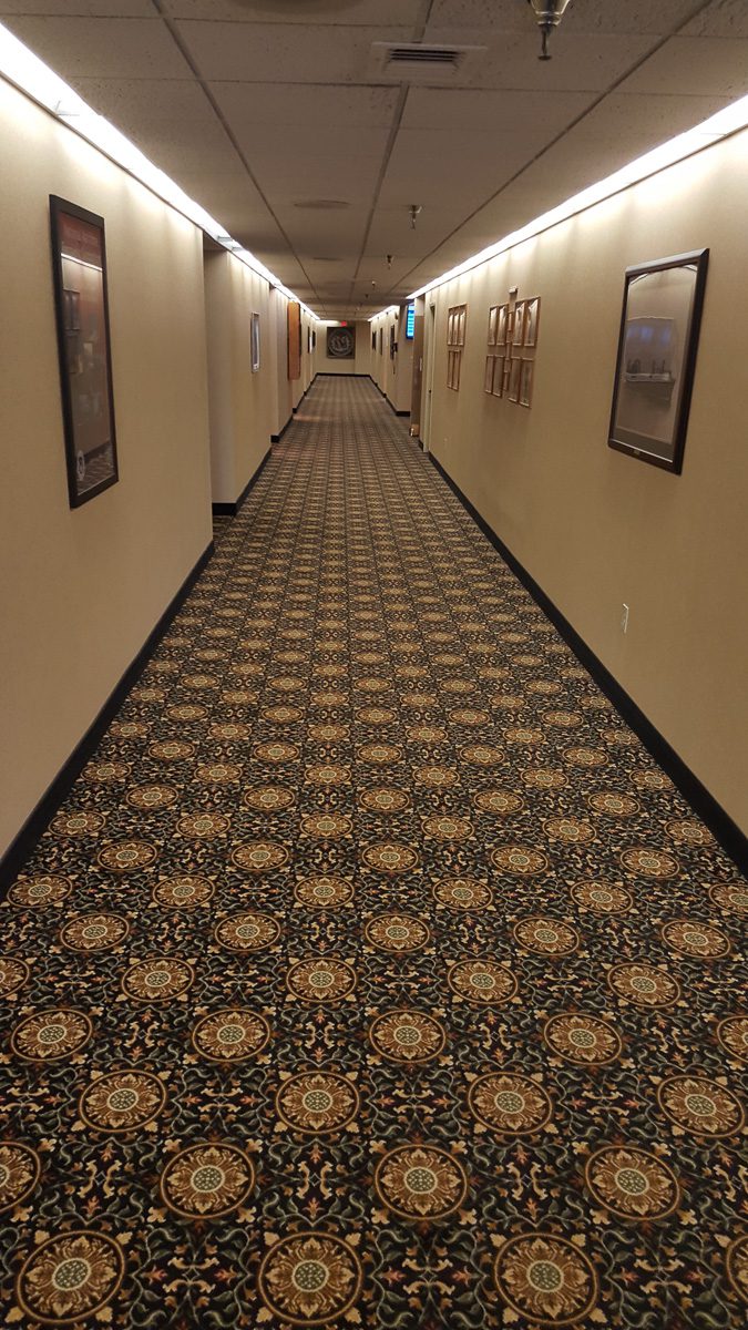 Narrow corridor with framed artwork