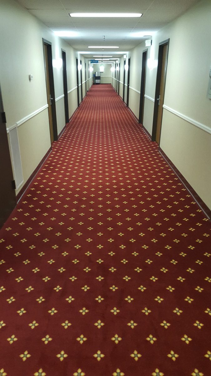 Long hallway with closed doors