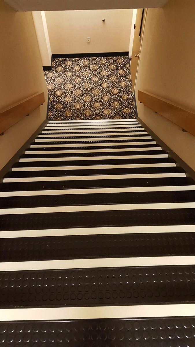 Stairwell leading to a carpeted floor