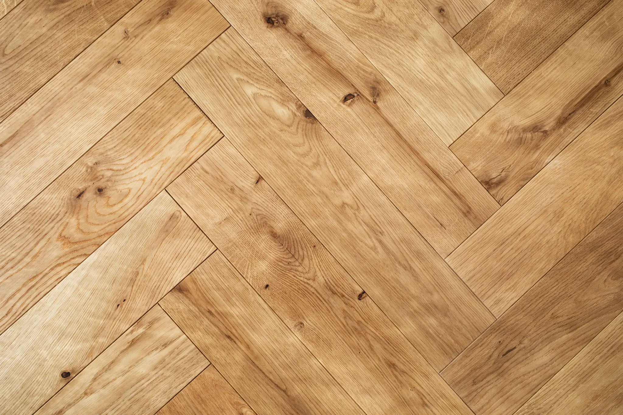 Herringbone pattern wooden floor close-up.