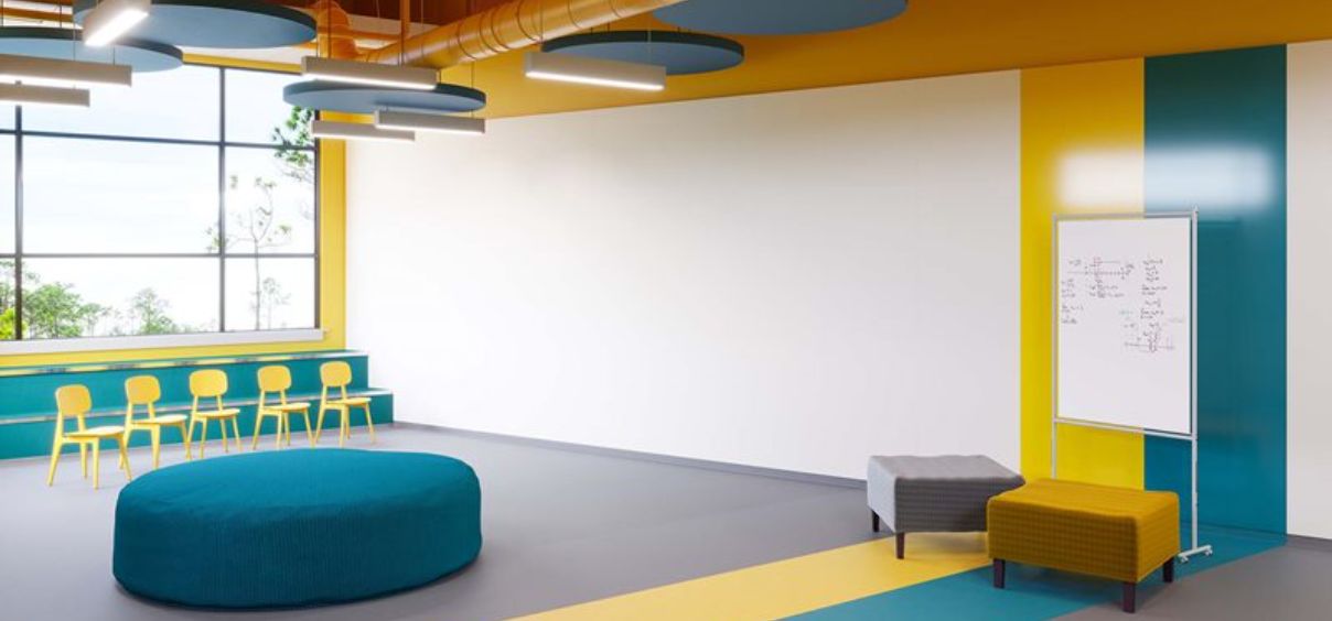 Colorful modern classroom with seating and whiteboard.