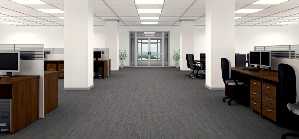 Modern open-plan office with cubicles and computers.