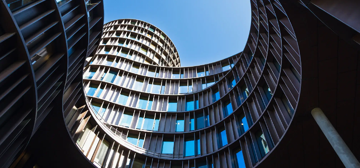 Curved modern building under blue sky.