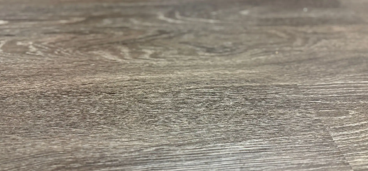 Dark wooden surface with visible grain pattern.