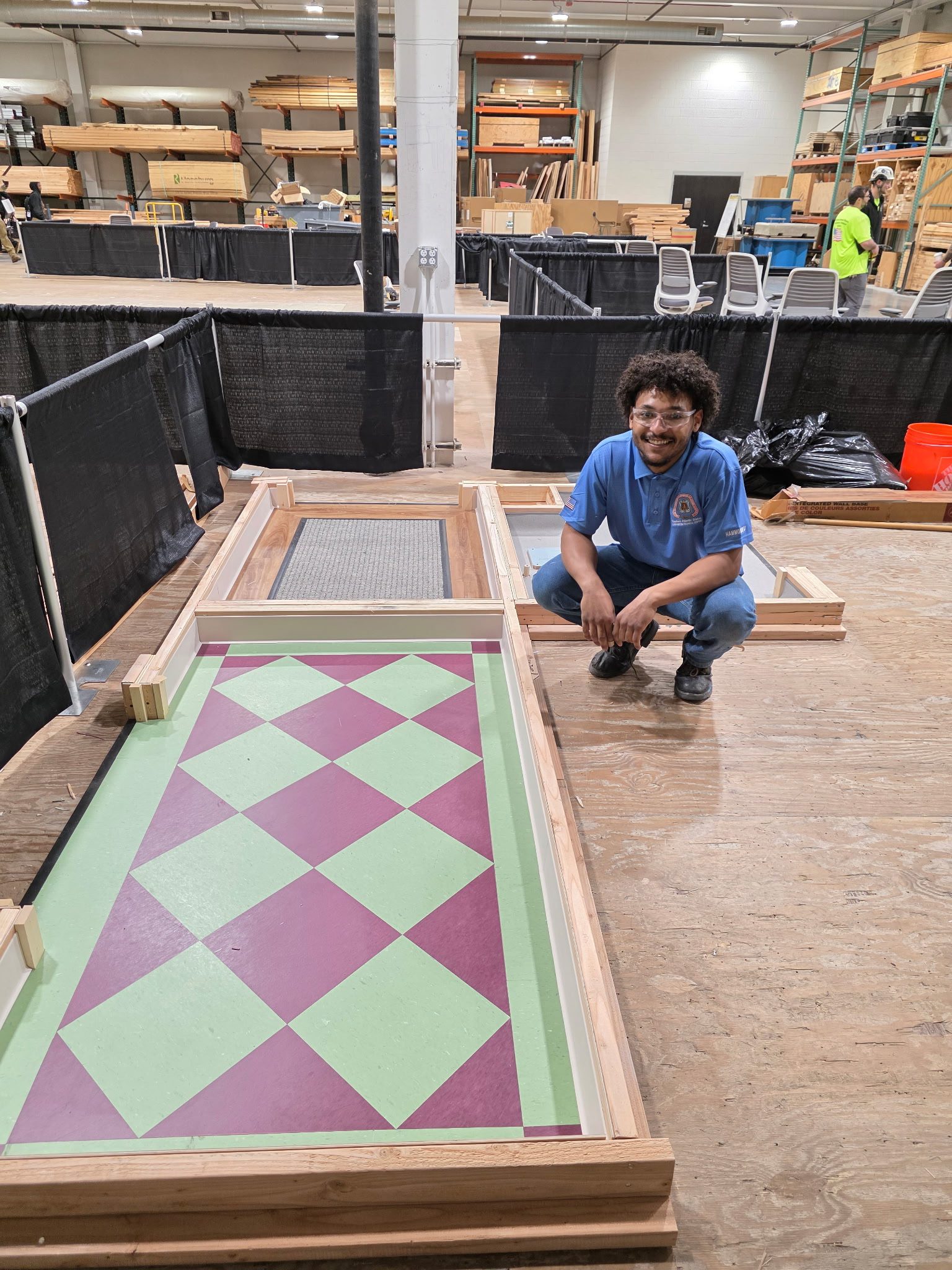 Person kneeling beside colorful construction project.
