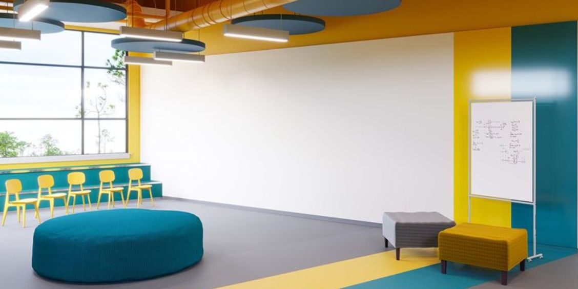 Colorful modern classroom with seating and whiteboard.